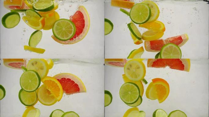 柑橘类水果的酸橙，柠檬，橙子，葡萄柚落入水中，带有飞溅和气泡，慢动作特写