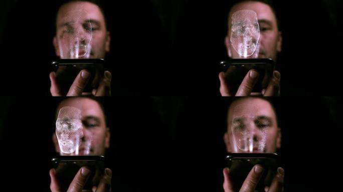 男性拿着智能手机，他的3D脸部全息图从屏幕上投射出来
