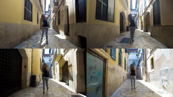 后视旅游妇女走在巴塞罗那狭窄的街道上穿着可爱的夏装享受欧洲暑假旅游度假冒险