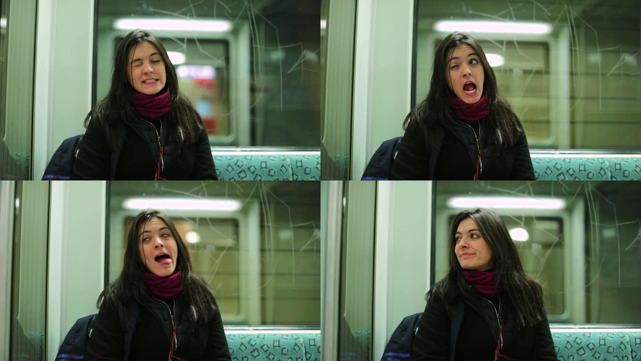 有趣的女孩在乘坐地铁时做着富有表现力的愚蠢的鬼脸看着镜头