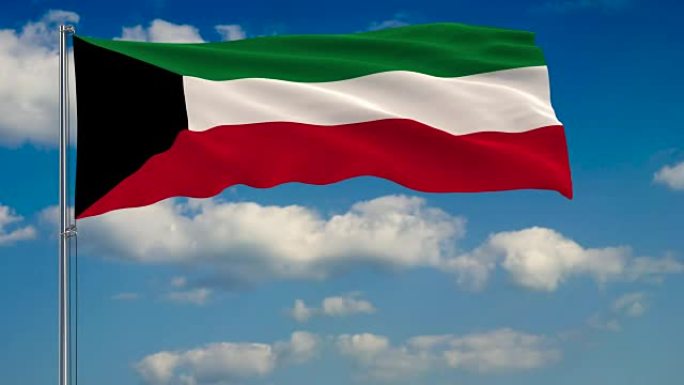 科威特国旗映衬着蓝天上漂浮的云朵