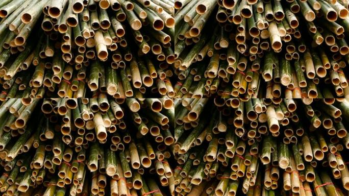 圆形交叉切片竹树干捆成堆，准备在亚洲用作建筑材料。自然质地。一堆砍伐的树。毁林概念。装饰和家具来源。