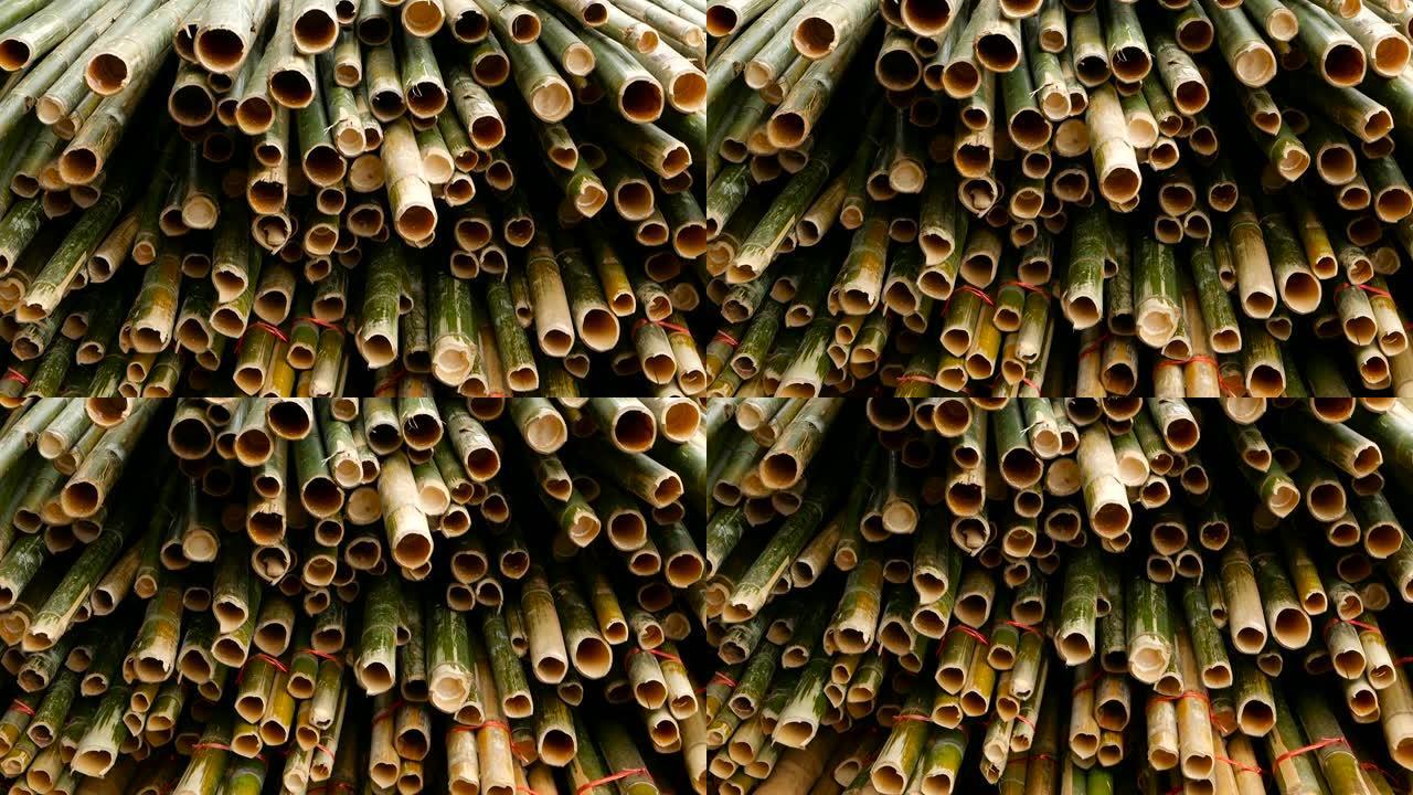 圆形交叉切片竹树干捆成堆，准备在亚洲用作建筑材料。自然质地。一堆砍伐的树。毁林概念。装饰和家具来源。