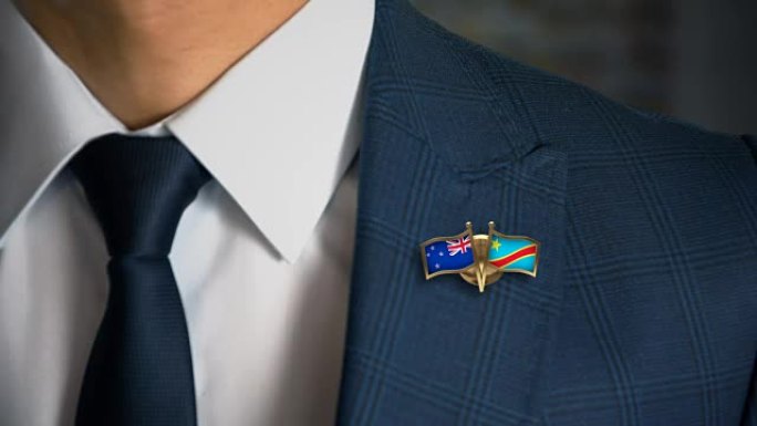 商人带着朋友国家的国旗走向相机钉新西兰-刚果民主共和国