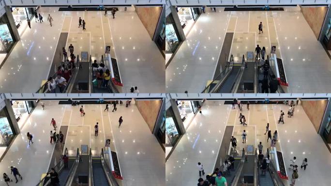 泰国曼谷带自动扶梯和人的室内流行购物中心的延时俯视图