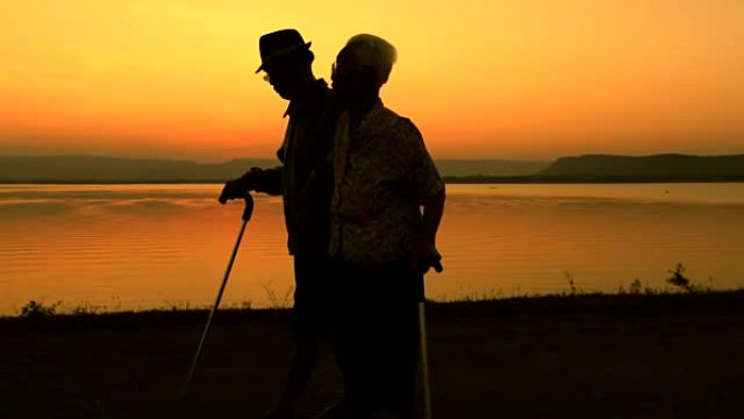 资深亚洲情侣在湖边散步，概念健康相爱，慢动作