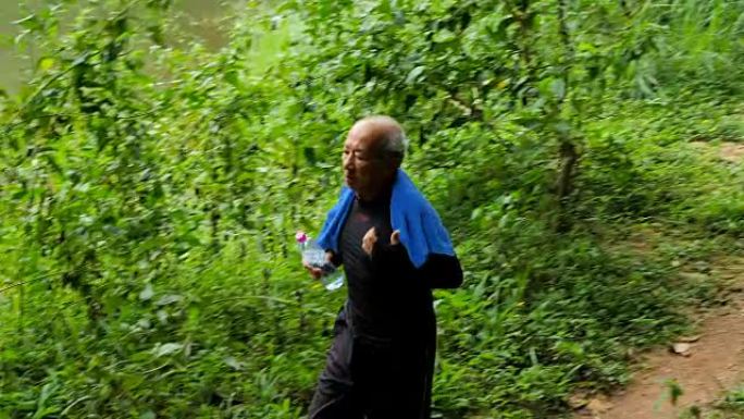 亚洲人在早晨的热带森林小径上奔跑。健康的运动生活方式。可以手动创建良好的健康状况。视频4K
