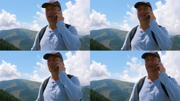 旅游男子在登山旅行时打电话给手机，低角度视角