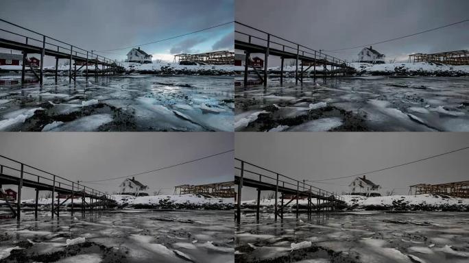 挪威罗弗滕群岛的暴风雪中的木屋在海岸线上漂浮的冰破裂的时间流逝