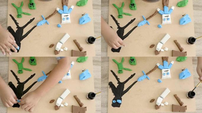 孩子的手在桌子上玩五颜六色的粘土和油漆。发展手指的精细运动技能和创造力，教育