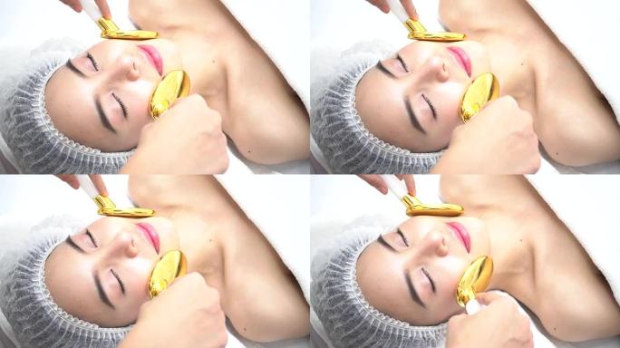 亚洲妇女在美容诊所脸上得到金勺医疗美容设备。改善皮肤光滑度并治愈痤疮的药物治疗