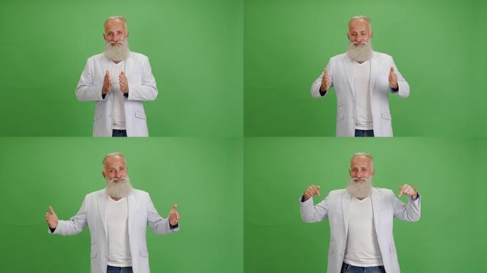 美丽的大胡子男人展示复制空间，并在绿色背景上竖起大拇指
