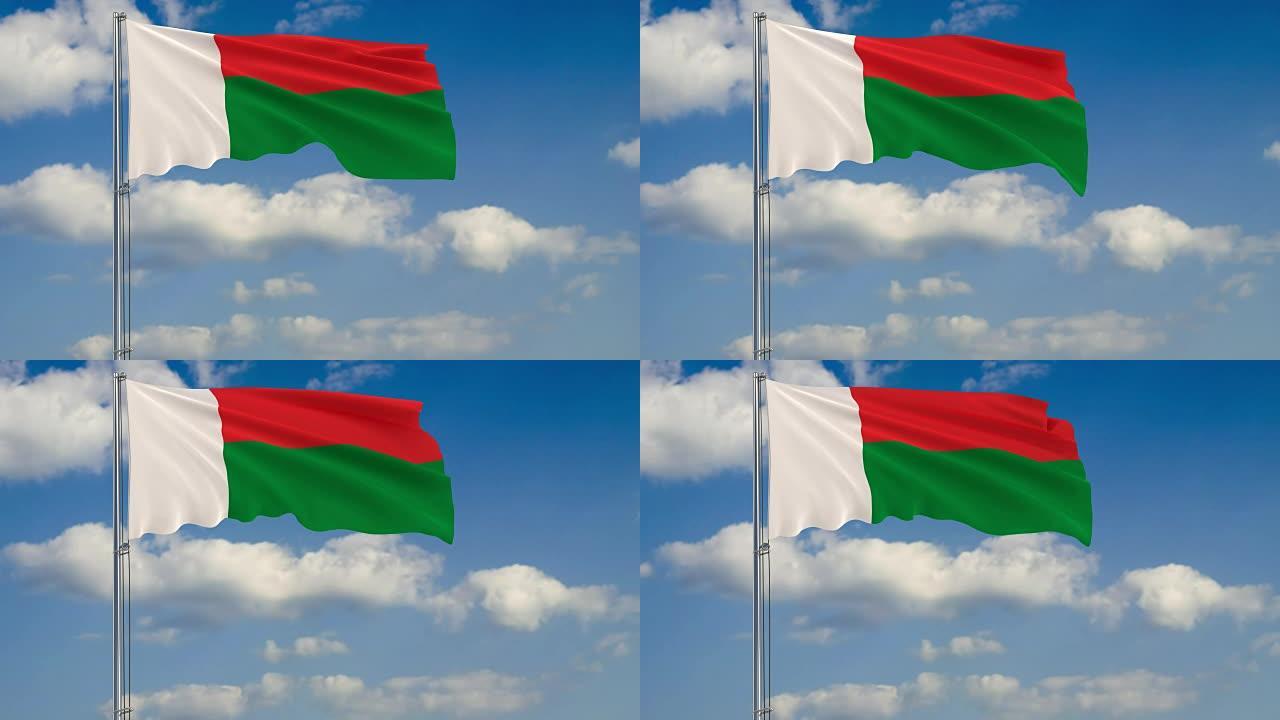 马达加斯加国旗映衬着漂浮在蓝天上的云朵