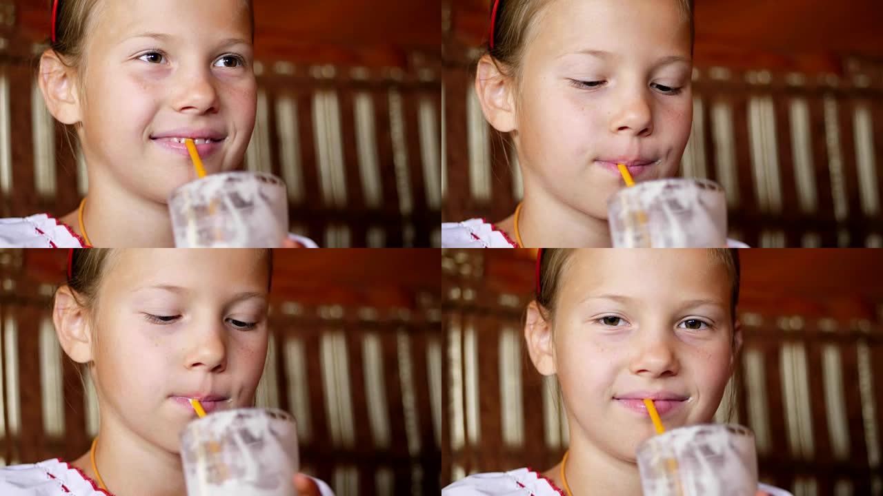 快乐微笑的少女儿童在咖啡馆喝奶昔。她穿着乌克兰民族服装，刺绣，维希万卡