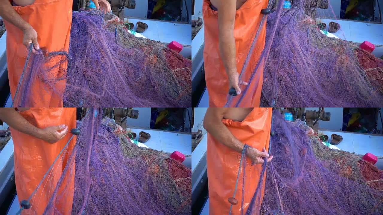 渔夫修理渔船上的渔网钓线