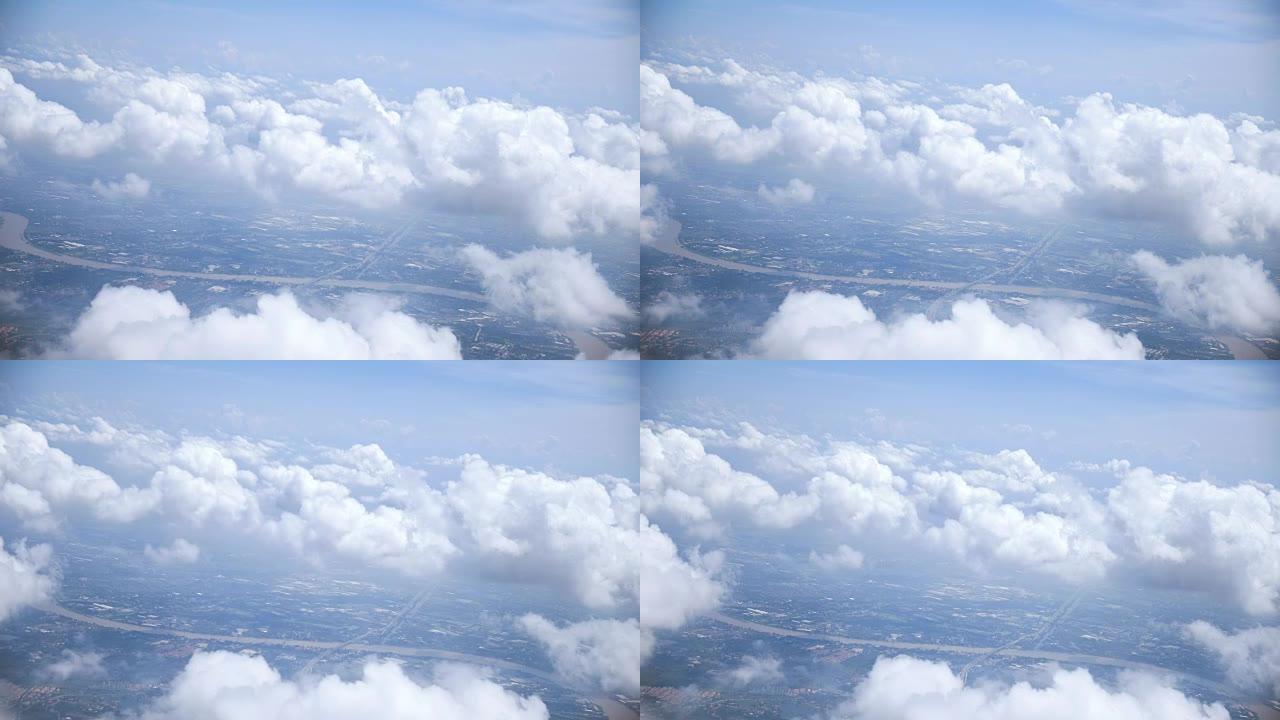 美丽的风景和云彩穿过飞机的窗户。概念: 旅行、度假、交通和舒适。