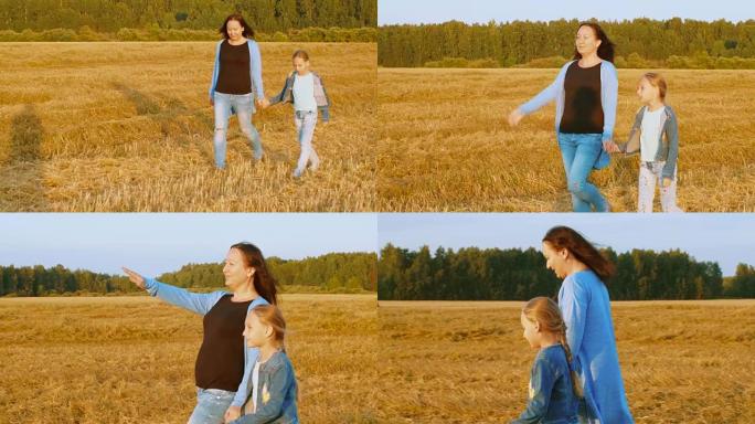 秋收时，年轻的妈妈和女儿在麦田上行走