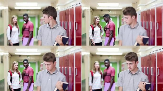 不快乐的男高中生在走廊被学生谈论