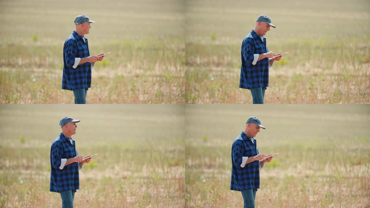 农业，农民在收割期间在田间使用数字平板电脑