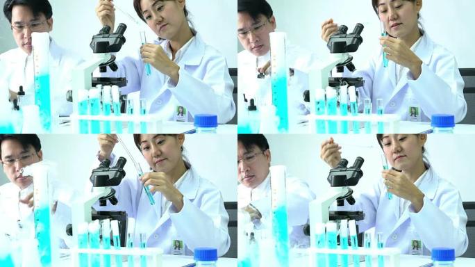 科学家的女性正在试验化学物质的化合物和吸收液体的试管。科学、测试开发和实验室行业的概念。
