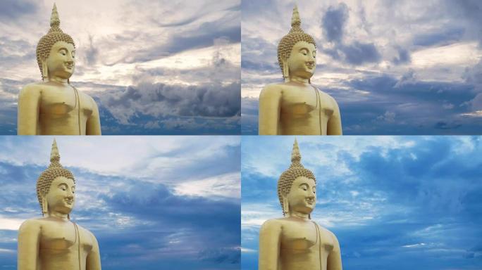 金色的大佛像，天空的时光流逝，日落时多云，背景为日出时多云。佛教徒的佛像