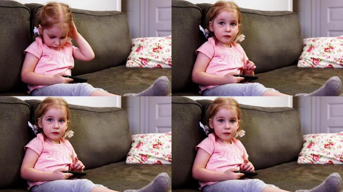 小女孩玩智能手机，看着相机