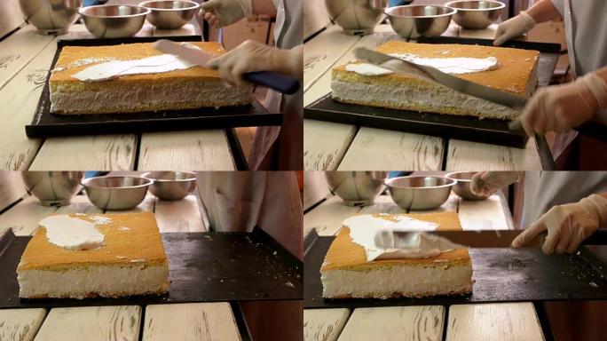 面包师在蛋糕上涂上白色奶油。