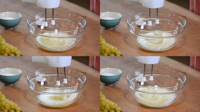 女性用手在碗中搅拌蛋清奶油。