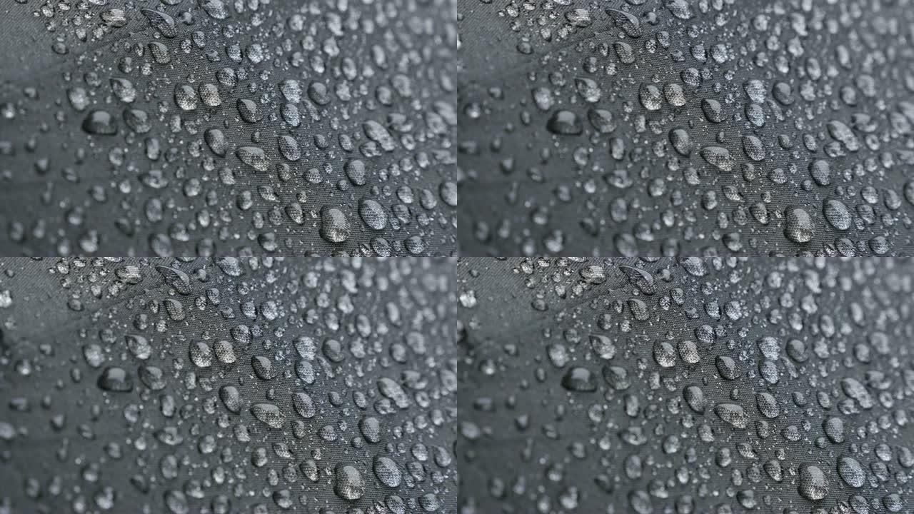 覆盖深色雨伞表面的微小雨滴4K 2160p 30fps UHD镜头-雨天防水织物保护表面的特写384