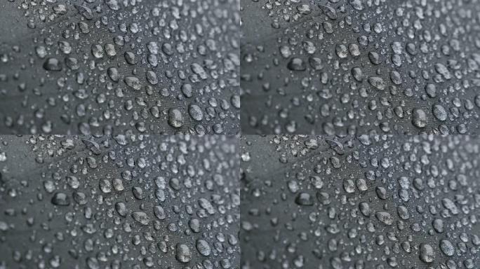 覆盖深色雨伞表面的微小雨滴4K 2160p 30fps UHD镜头-雨天防水织物保护表面的特写384