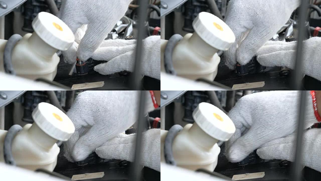 关闭机械师的手松开并拧紧汽车电池电源的盖子，用于倾倒蒸馏水补充电源维护