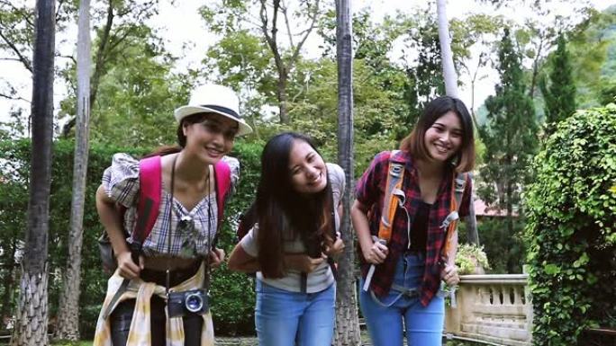 慢动作亚洲年轻人与朋友背包一起散步和徒步旅行，快乐的朋友正在拍照和自拍，在假日概念旅行中放松时间