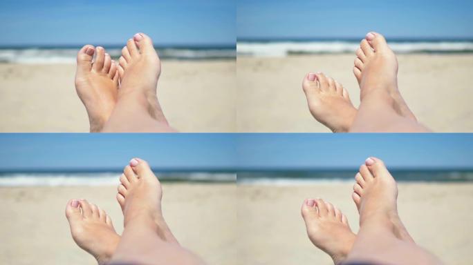 4k分辨率慢动作60fps的女人躺在沙滩上的脚