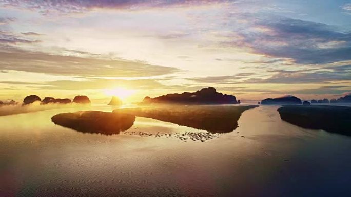 鸟瞰图无人机拍摄了早晨在泰国攀牙省的Ban Sam Chong Tai村美丽的日出