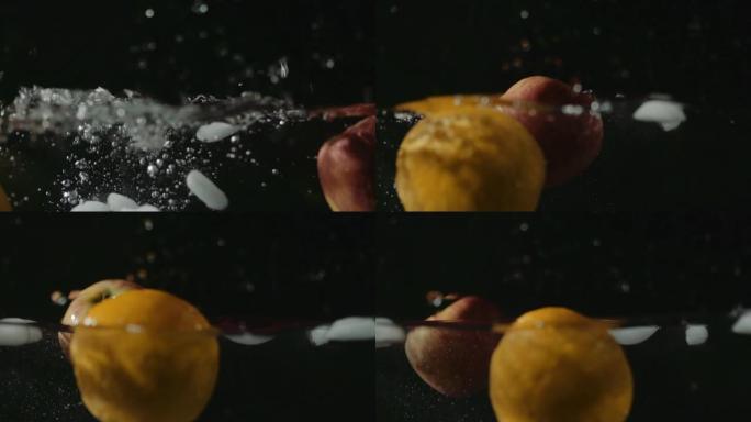橙子，苹果和冰块掉入水中