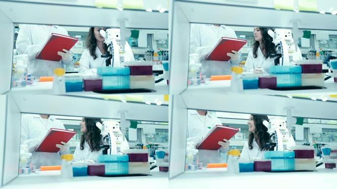 在实验室工作的科学家，在实验室里观察显微镜寻找治疗方法的研究人员，概念科学，慢动作