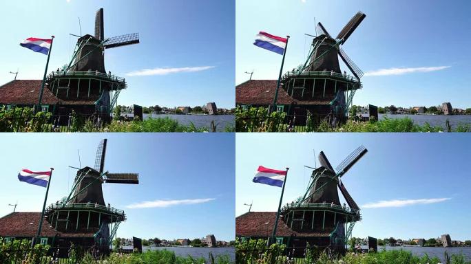 游客夫妇在荷兰阿姆斯特丹附近的Zaanse Schans拍摄传统风车的照片