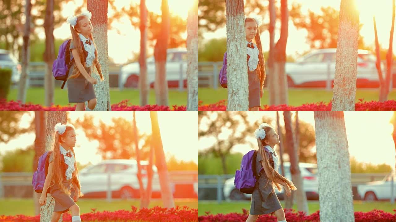 日落时分，又小又漂亮的女学生在公园里散步