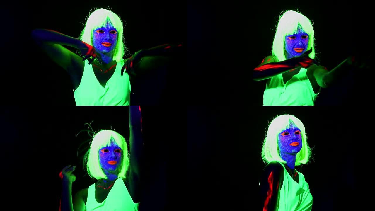 女人用UV面部彩绘，假发，发光的衣服在镜头前跳舞，肩膀射击。高加索女人。。