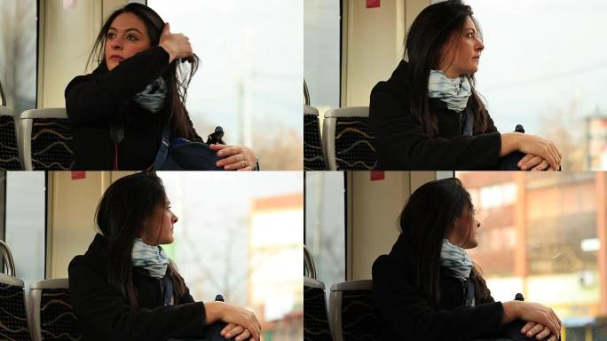 坐电车的女人看着窗外。旅游女孩在乘坐地铁时调整头发，凝视外面的风景