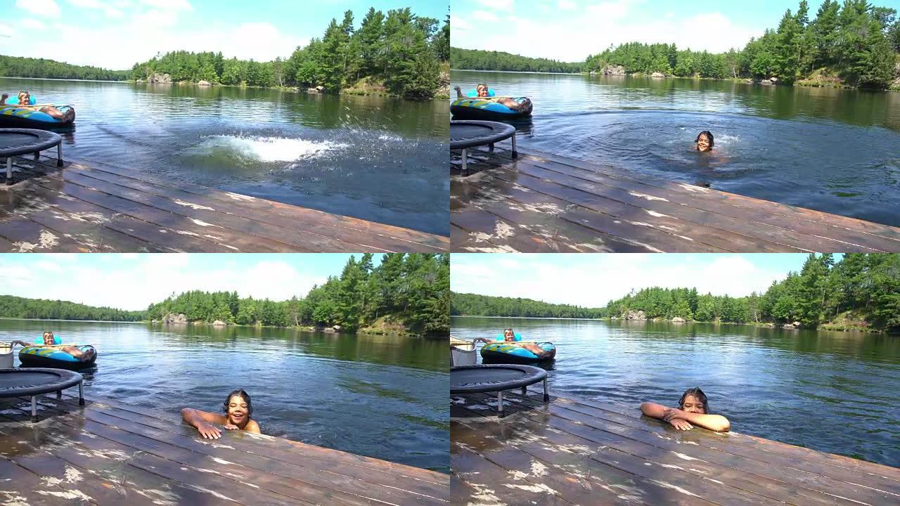 夏天，一个男孩从码头跳进美丽的北部湖泊。