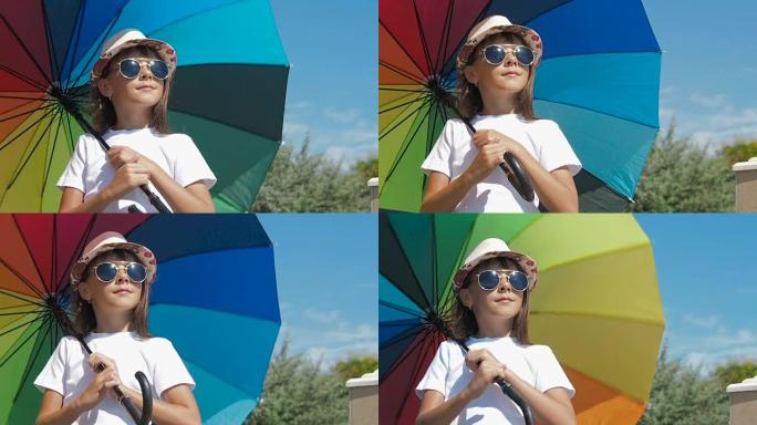 一个戴着墨镜和彩色雨伞的女孩。