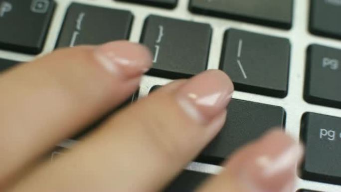 查找计算机键盘上的作业按钮，女性手指按键