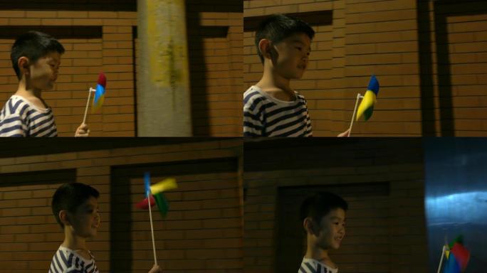 亚洲男孩在户外散步和玩风车