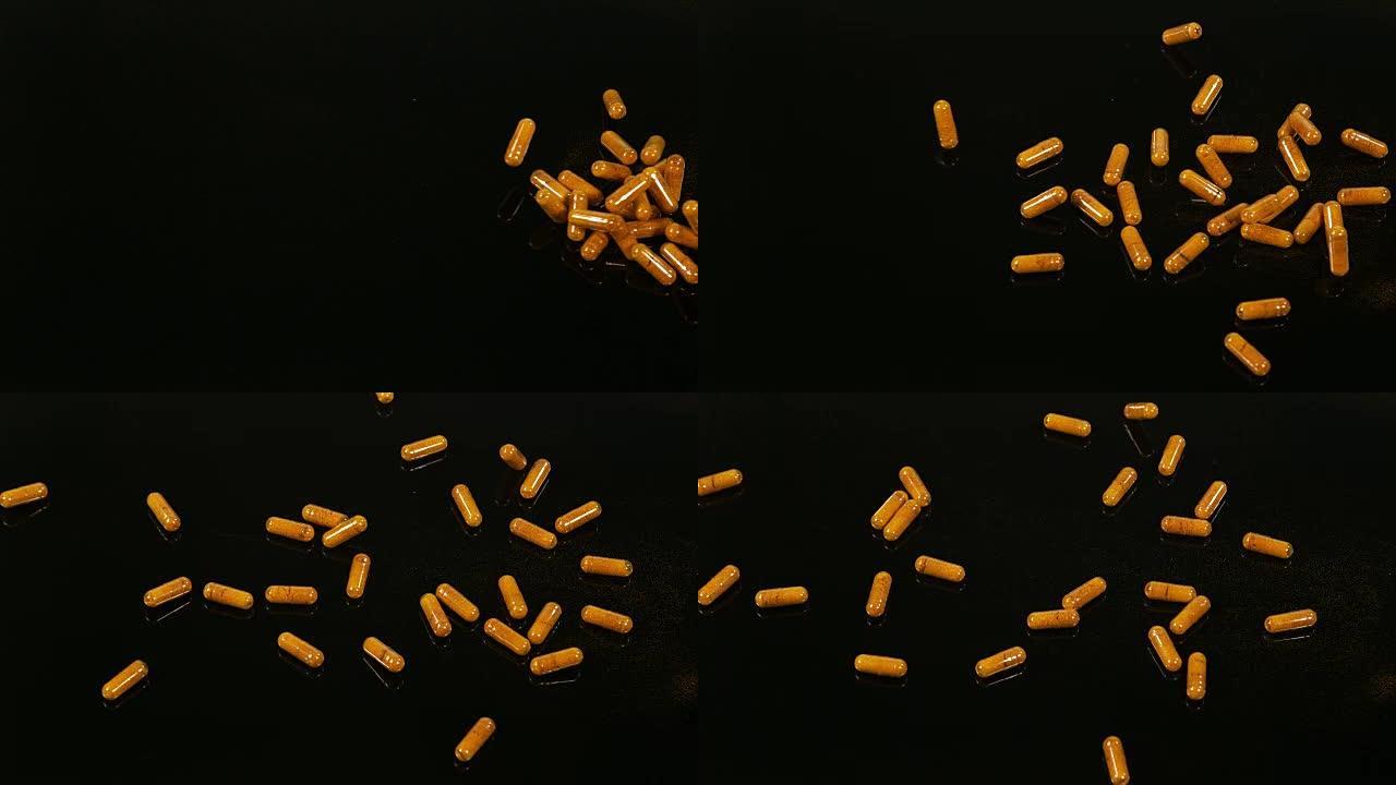 姜黄，姜黄龙果，落在黑色背景上的胶囊，印度香料，慢动作4K