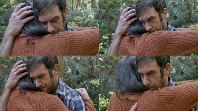 悲伤的男人拥抱一个女人，帮助他度过难关