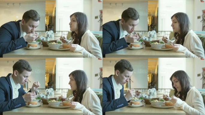 男人和女人在咖啡馆吃午饭。商务午餐