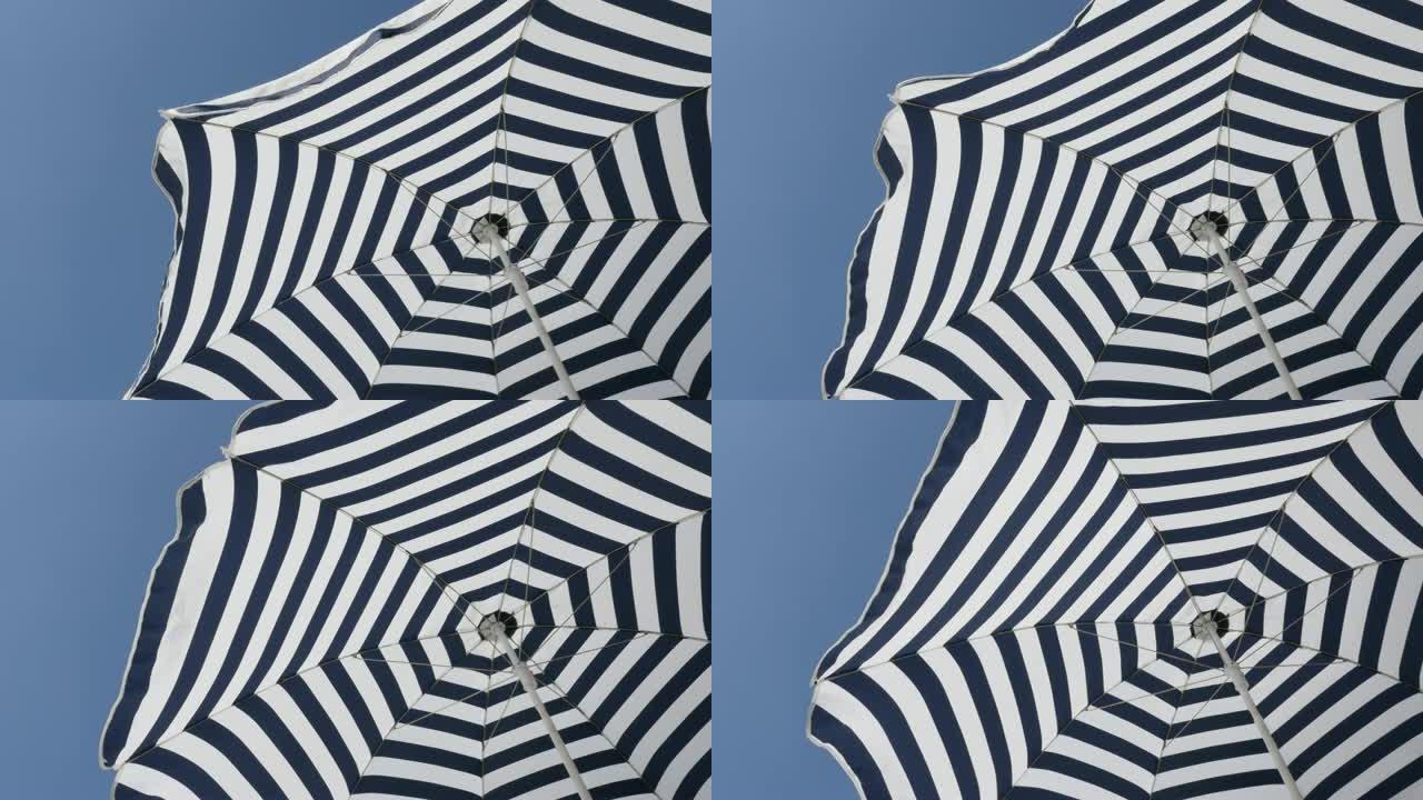 条纹伞防晒织物随风移动4K 2160p 30fps超高清镜头-蓝色和白色沙滩阳伞，催眠效果3840x