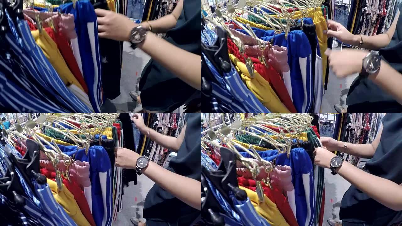 亚洲年轻女性在服装店购物的特写镜头