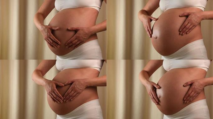 孕妇用手摸肚子